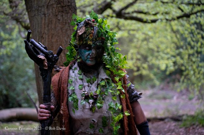 an image of a character whose life is deeply embedded with that of trees, with woody skin and leaves covering their skin